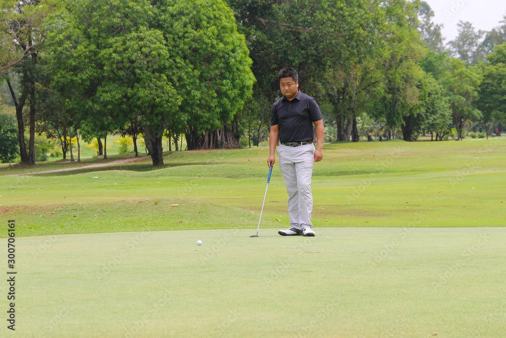 Fototapeta premium Golfer playing golf in beautiful golf course in the evening golf course with sunshine in thailand