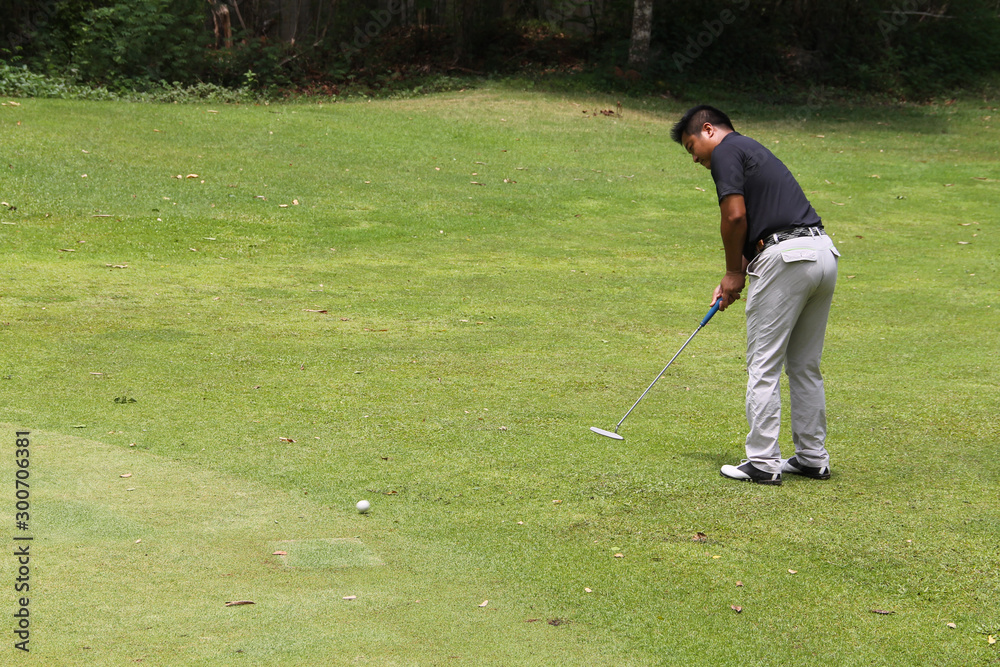 Fototapeta premium Golfer playing golf in beautiful golf course in the evening golf course with sunshine in thailand