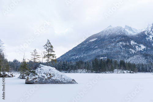 partly frozen lake hintersee with snow in winter and rocks © Jochen Netzker