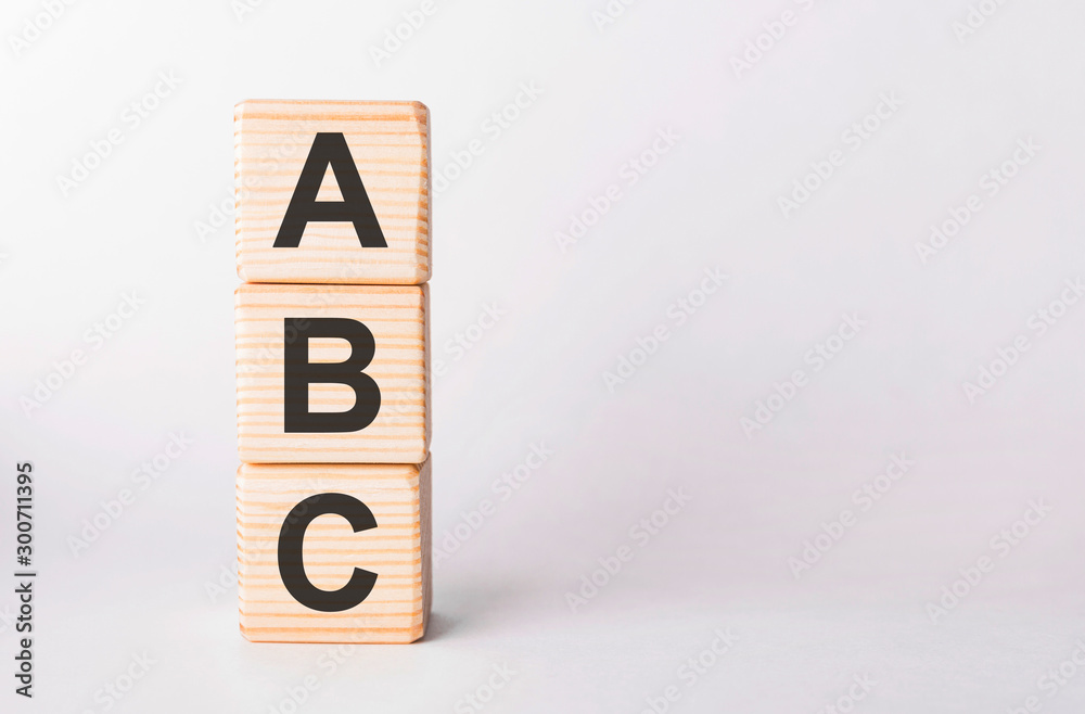 ABC letters of wooden blocks in pillar form on white background, copy space ABC letters of wooden blocks in pillar form on white background, copy space