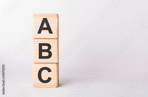 ABC letters of wooden blocks in pillar form on white background, copy space photo