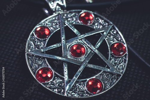 Bild auf Leinwand Witch amulet, have 5 pointed star and red jewelry on it