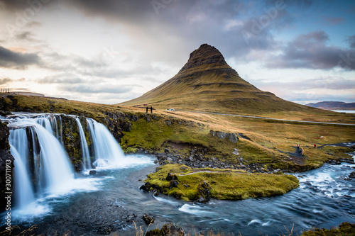 The picturesque sunset over landscapes and waterfalls. Kirkjufell mountain, Iceland photo