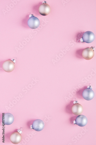 Christmas holiday background with decorations for the Christmas tree, balls of pastel colors on a delicate pink trend background.