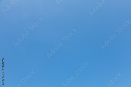 View of clear blue sky under sunlight on summer day.
