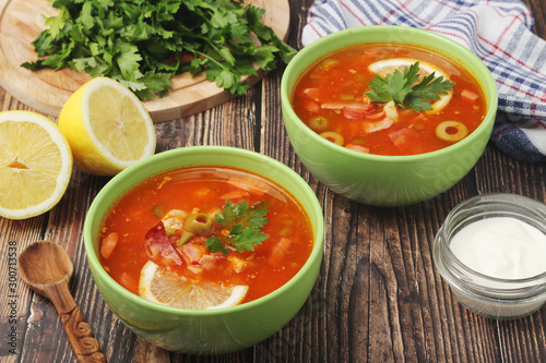Two bowls with traditional Russian soup solyanka