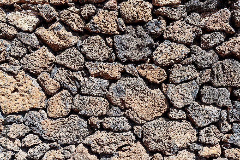 close-up shot of dry stone wall made of volcanic rocks background close-up shot of dry stone wall made of volcanic rocks background
