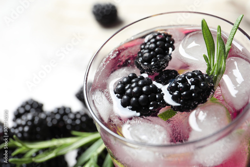 Delicious refreshing blackberry lemonade on table, closeup view