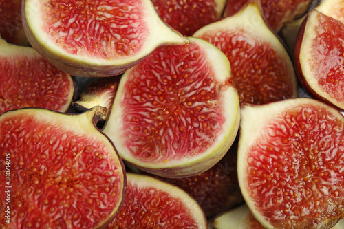 Tasty ripe cut fig fruits as background  closeup