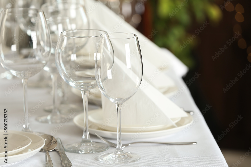 Table setting with empty glasses, plates and cutlery indoors Table setting with empty glasses, plates and cutlery indoors