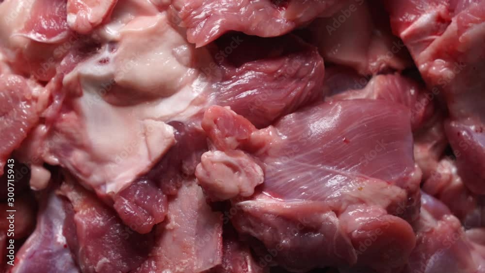 Raw turkey meat pieces in tray rotating in microwave defrosting top view. Raw turkey meat pieces in tray rotating in microwave defrosting top view.