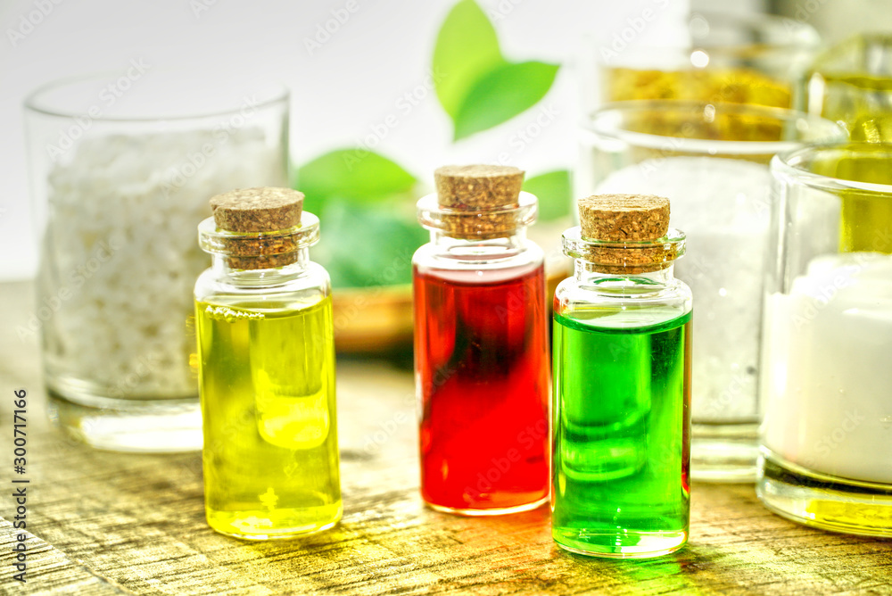 Closeup tree organic oil in the bottles on the table for produce apothecary cosmetic product.