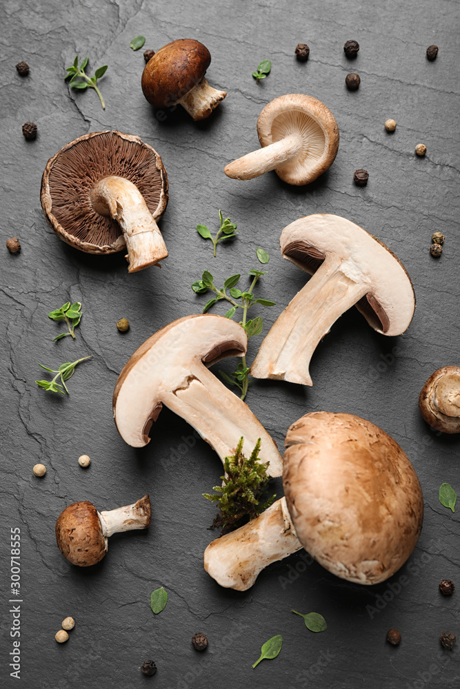 Flat lay composition with fresh wild mushrooms on black table