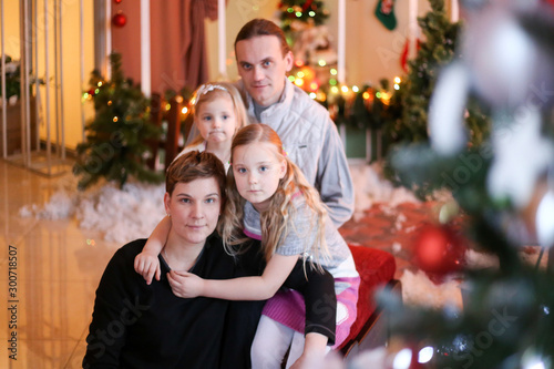 family in christmas decorations smiling and hugging