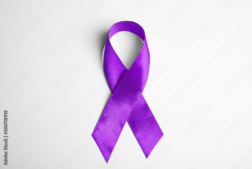 Purple ribbon on white background, top view. Domestic violence awareness
