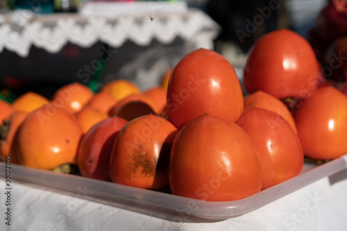 Persimmons on a counter for sale