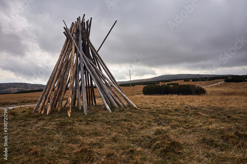 Poles for marking tourist trails in a meadow on a plain during autumn in the Giant Mountains in Poland.