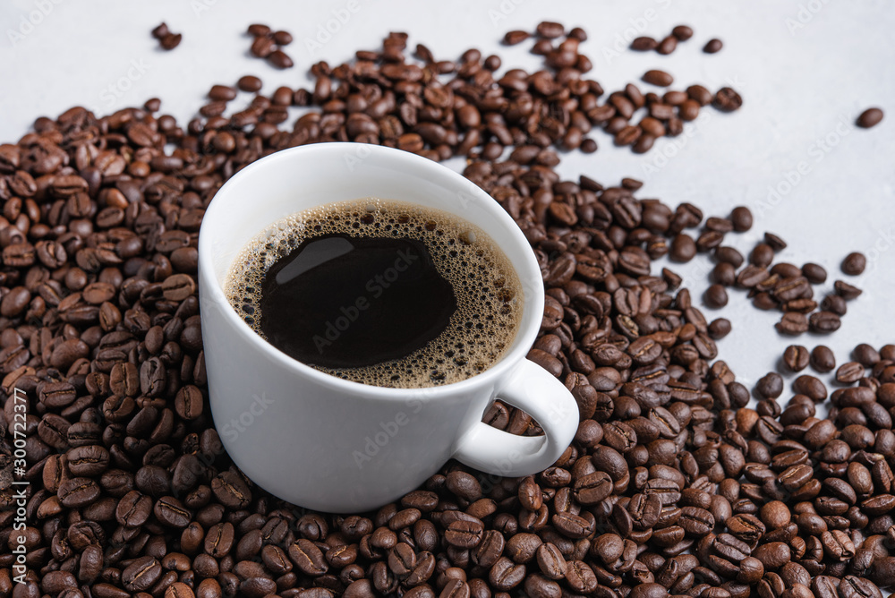 Cup of coffe stay on coffee beans. Macro and close up Cup of coffe stay on coffee beans. Macro and close up