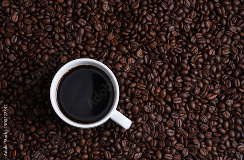 cup of coffee espresso on coffee beans brown seed texture background full wallpaper