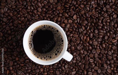 cup of coffee espresso on coffee beans brown seed texture background full wallpaper