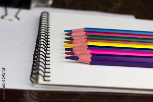 color pencils on a notebook close-up, macro	