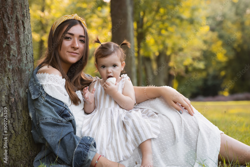 A little girl walks with her mother outdoors. A little girl walks with her mother outdoors.