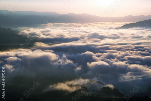 Dense fog with amazing light. A beautiful landscape with high mountains. Majestic spring morning. Location place Carpathian, Ukraine, Europe.