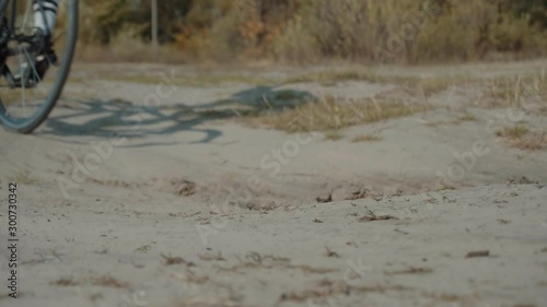 Strong Professional Cyclist Athlete On Crosscoutry Competition.Cyclist Riding On Gravel Bike In Slow Motion.Leader On  Race Hurries To Finish Line.Cycling Race On Gravel Road.Bicycle Racing On Trail.  photo