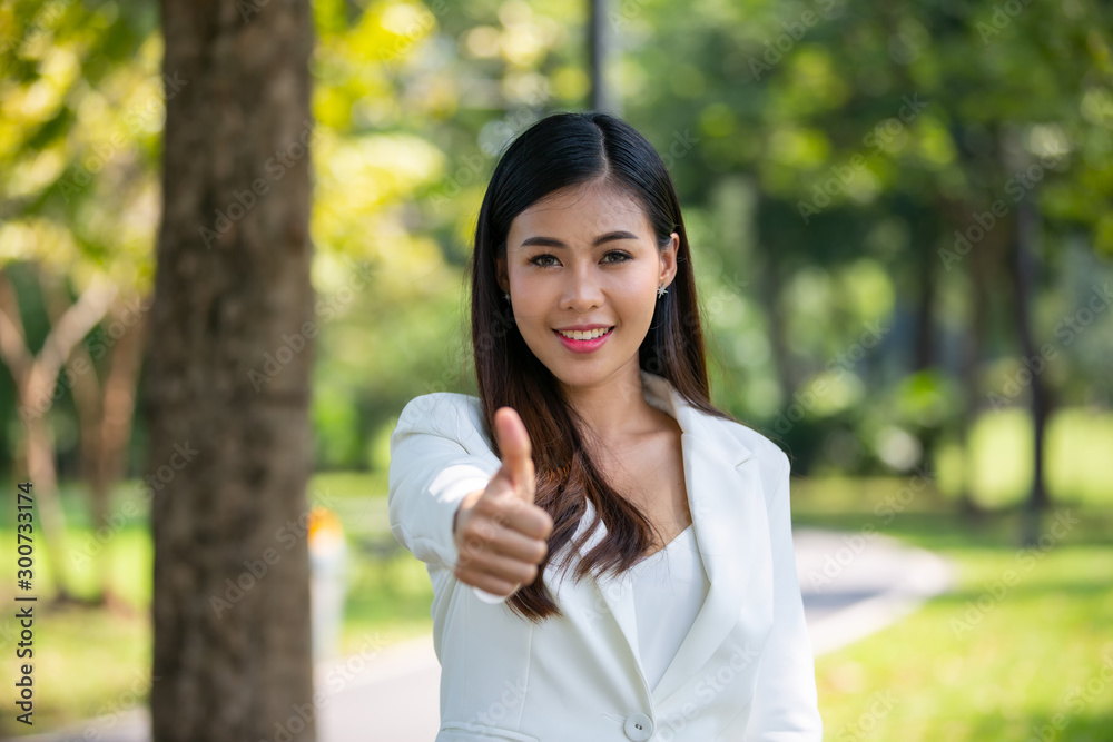 Young happy cheerful woman showing thumb up Young happy cheerful woman showing thumb up