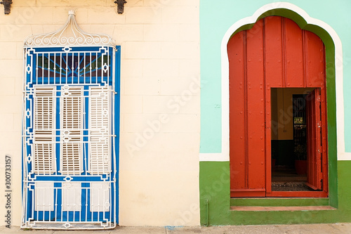 Photography red door in green wall, sancti spiritus - cuba