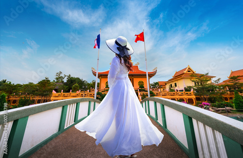 Asian female tourists wearing a white dress visit Lung Ho's house in Nakhon Phanom province,Thailand. photo