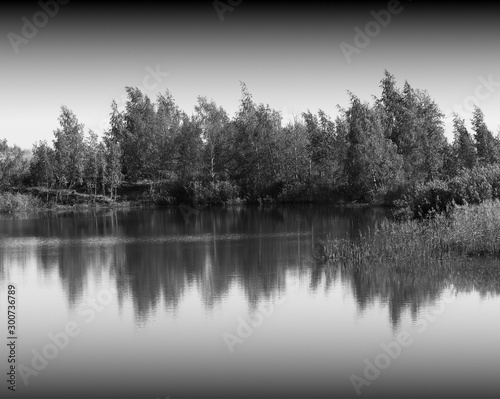 Dramatic forest reflections in smooth river landscape background