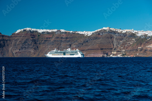 A cruise ship on the blue Aegean Sea near Santorini Island in the Greek Islands © Phillip