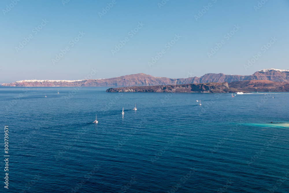 Yachts and sailing boats on the Aegean Sea in the Greek Islands near Santorini Island