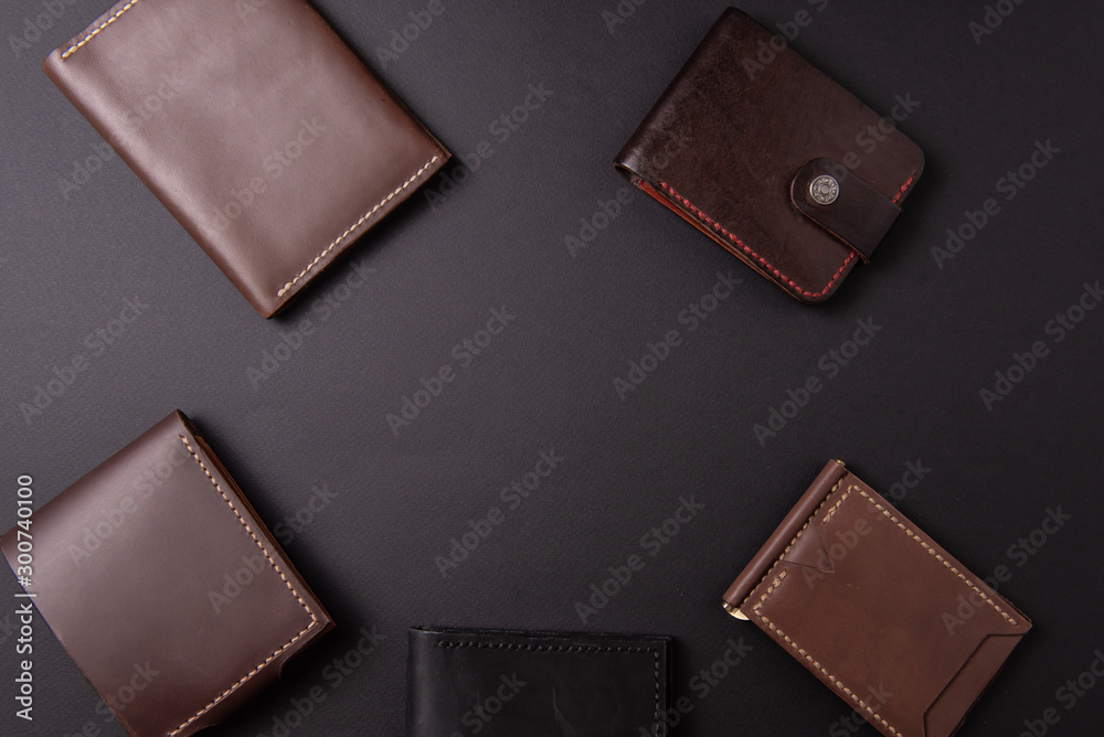 leather wallets on a black background with space for an inscription. Leather craft concept. leather wallets on a black background with space for an inscription. Leather craft concept.