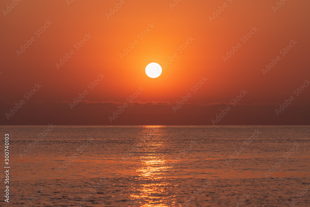 Sunset at sea. The sun is setting over the horizon