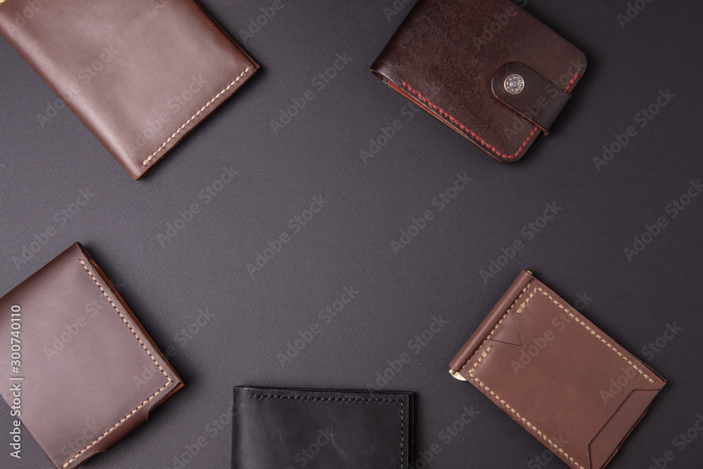 leather wallets on a black background with space for an inscription. Leather craft concept. leather wallets on a black background with space for an inscription. Leather craft concept.