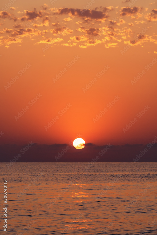 Sunset at sea. The sun is setting over the horizon Sunset at sea. The sun is setting over the horizon