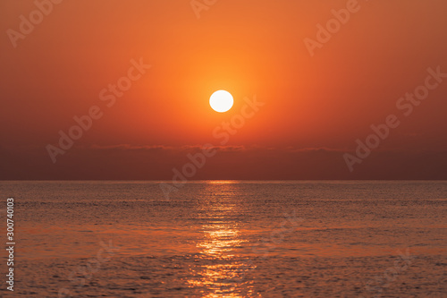 Sunset at sea. The sun is setting over the horizon