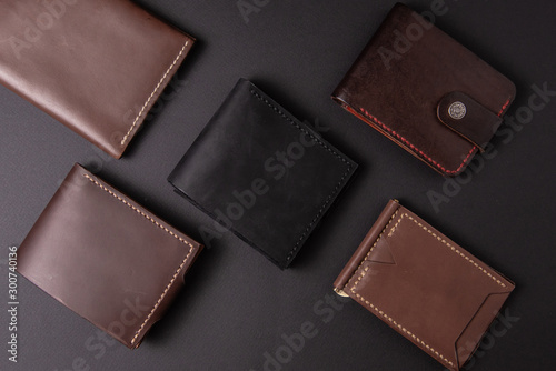 leather wallets on a black background with space for an inscription. Leather craft concept. photo