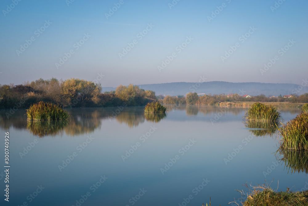 Peaceful scene along the calm water of a river in Transylvania, eastern Europe