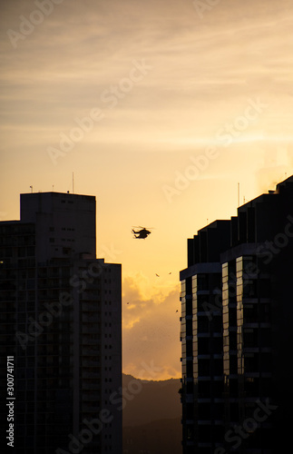 Helicopter flying in Panama City over City at Sunset