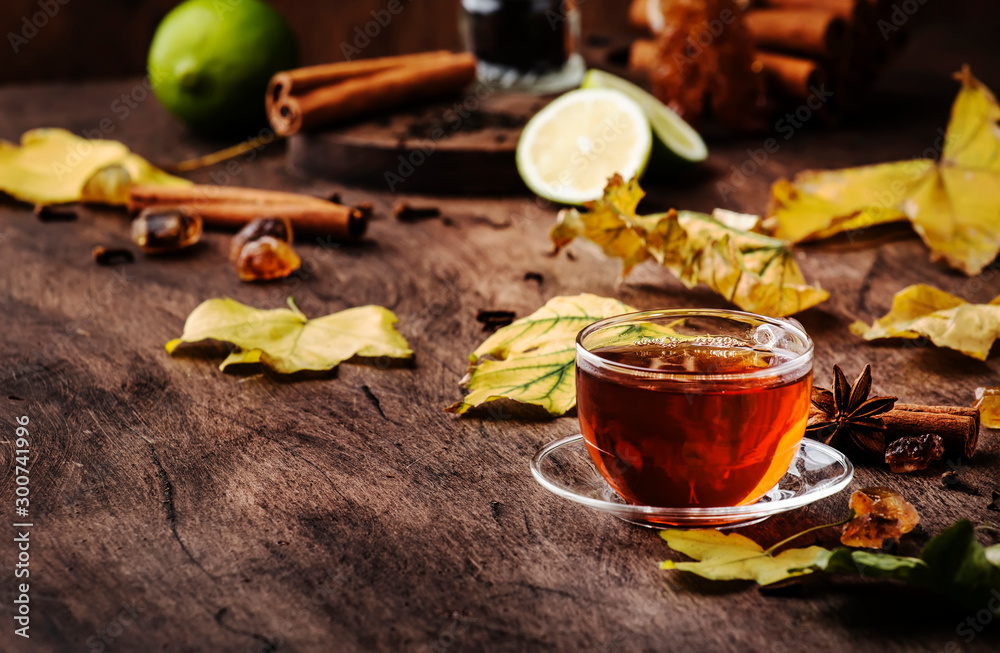 Autumn hot black tea in glass cup, old wooden table background, selective focus - obrazy, fototapety, plakaty 