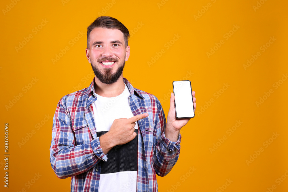 Young handsome man with facial hair posing yellow gray wall with a lot of copy space for text. Portrait of confident bearded male, wearing blank white oversized t-shirt. Isolated, background. Young handsome man with facial hair posing yellow gray wall with a lot of copy space for text. Portrait of confident bearded male, wearing blank white oversized t-shirt. Isolated, background.