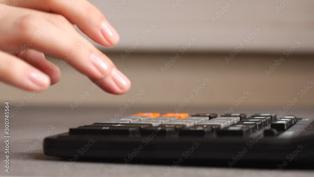 Close up of female accountant or banker making calculations. Home finances, investment, economy, saving money or insurance concept. Hands closeup. Close up of female accountant or banker making calculations. Home finances, investment, economy, saving money or insurance concept. Hands closeup.
