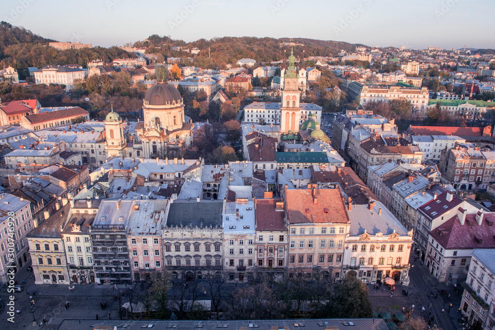 Lviv, Ukraine - October 24, 2019: Beautiful Ratusha view of the Dominican Cathedral, the Assumption Church and the historic center of Lviv, Ukraine, on a sunny evening. Roofs and streets