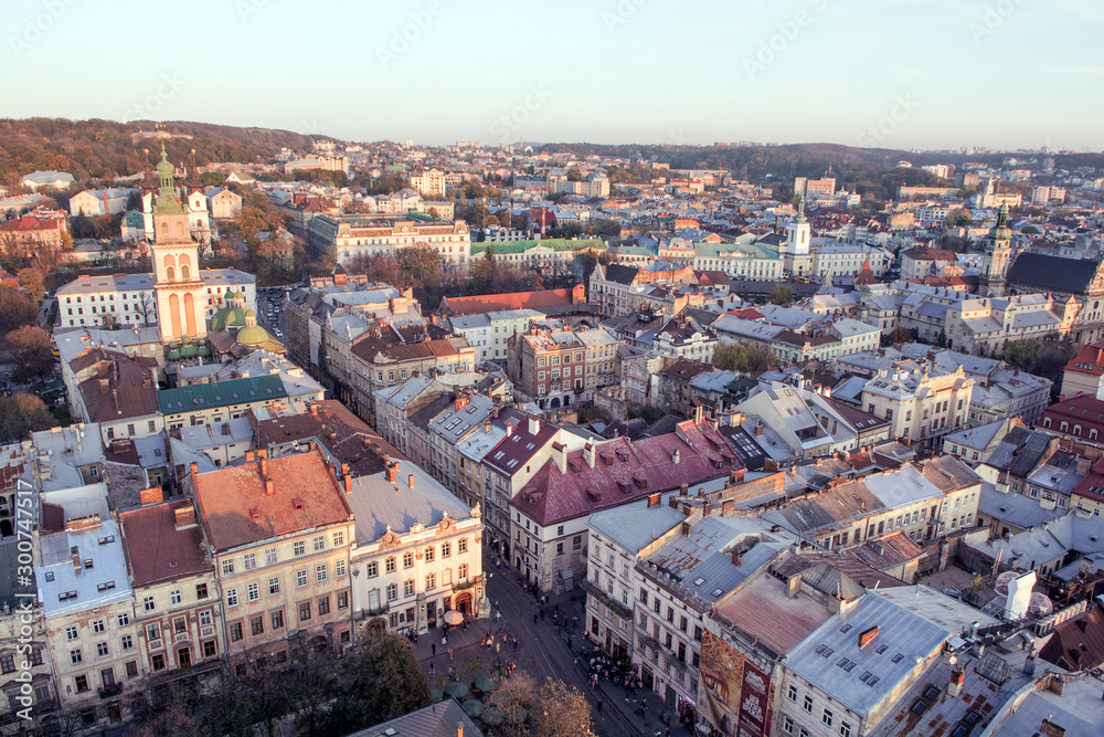Lviv, Ukraine - October 24, 2019: Beautiful Ratusha view of the Assumption Church and the historic center of Lviv, Ukraine, on a sunny evening. Roofs and streets