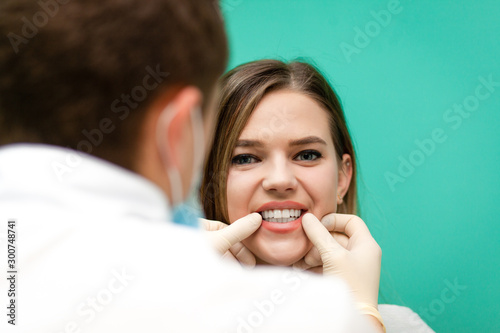 Young girl with beautiful teeth undergoes a checkup at the dentist