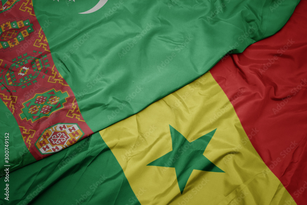 waving colorful flag of senegal and national flag of turkmenistan. waving colorful flag of senegal and national flag of turkmenistan.