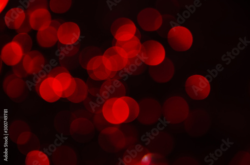 Abstract pattern of red bokeh garland lights on a dark background